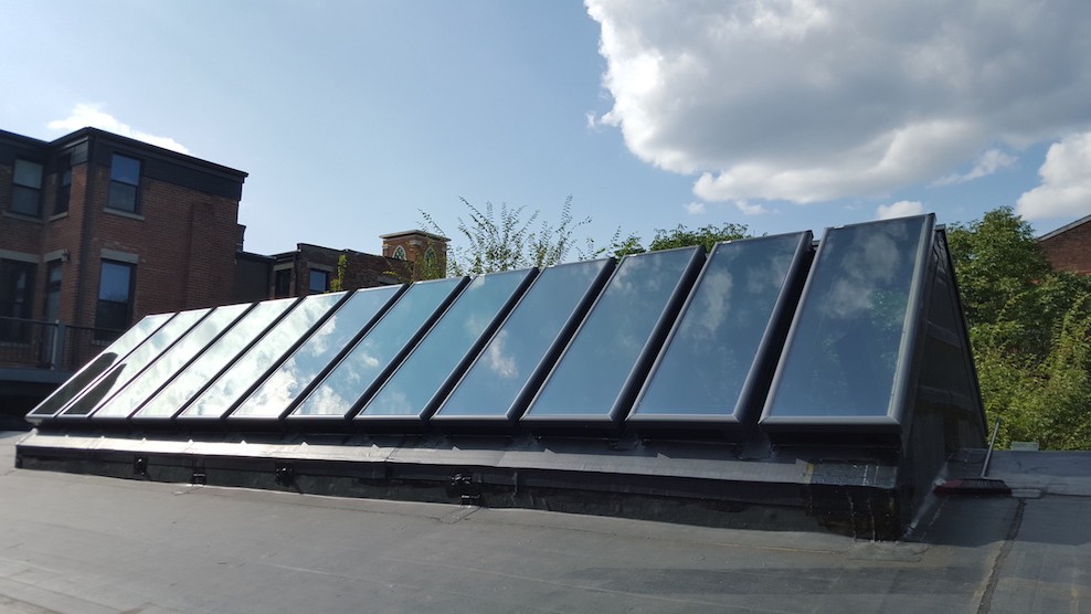 Man Using Measuring Tape in Factory Setting Man Using Measuring Tape in Factory Setting